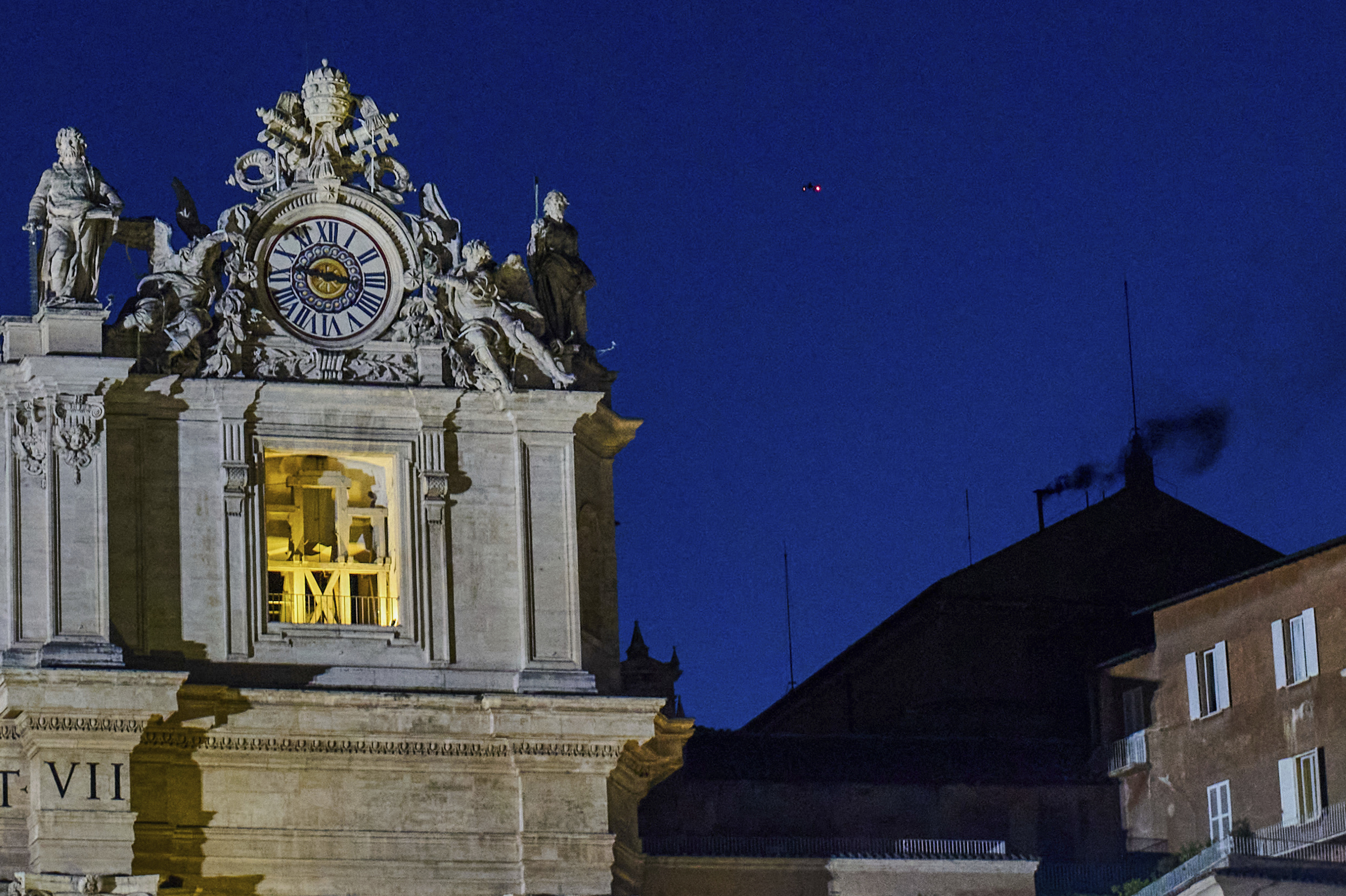 Black smoke billows from the chimney of the Sistine Chapel.