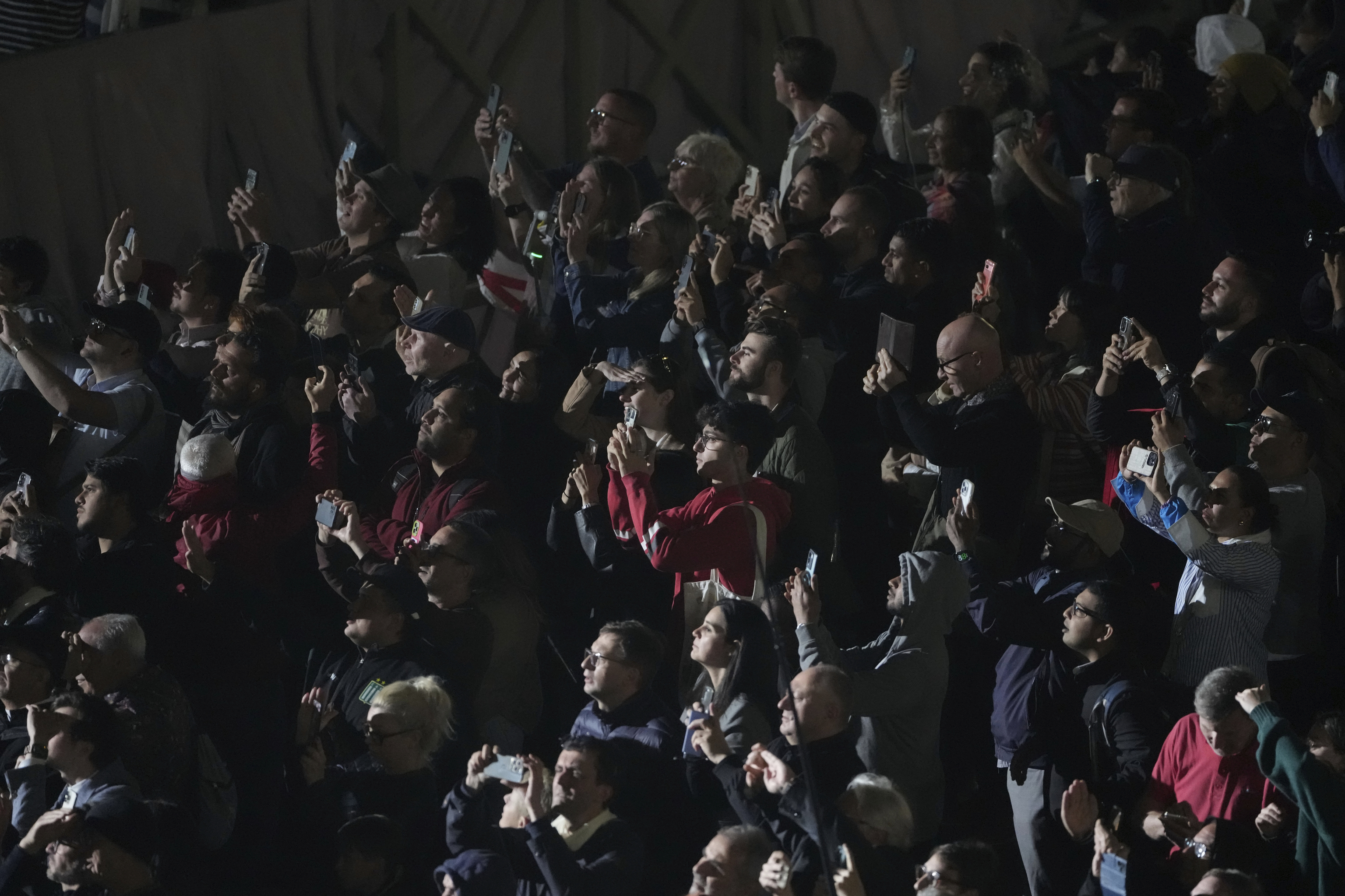 People react in St. Peter's Square at the Vatican after black smoke.