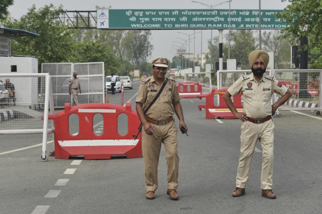 Policemen on the road leading to the airport in Amritsar, India,