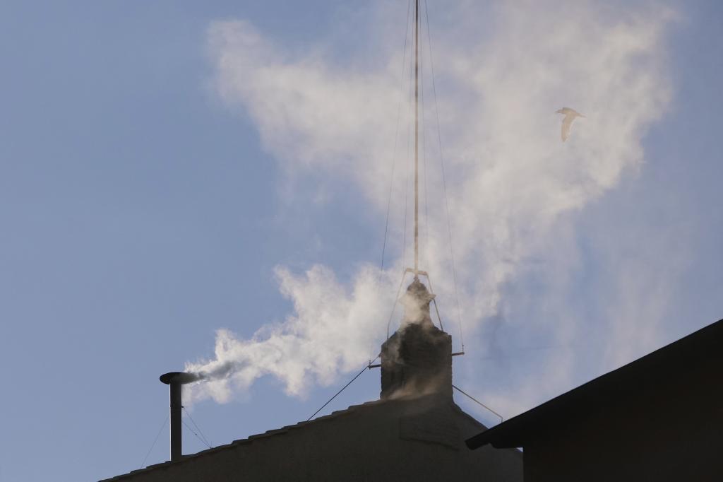 White smoke billows from the chimney of the Sistine Chapel