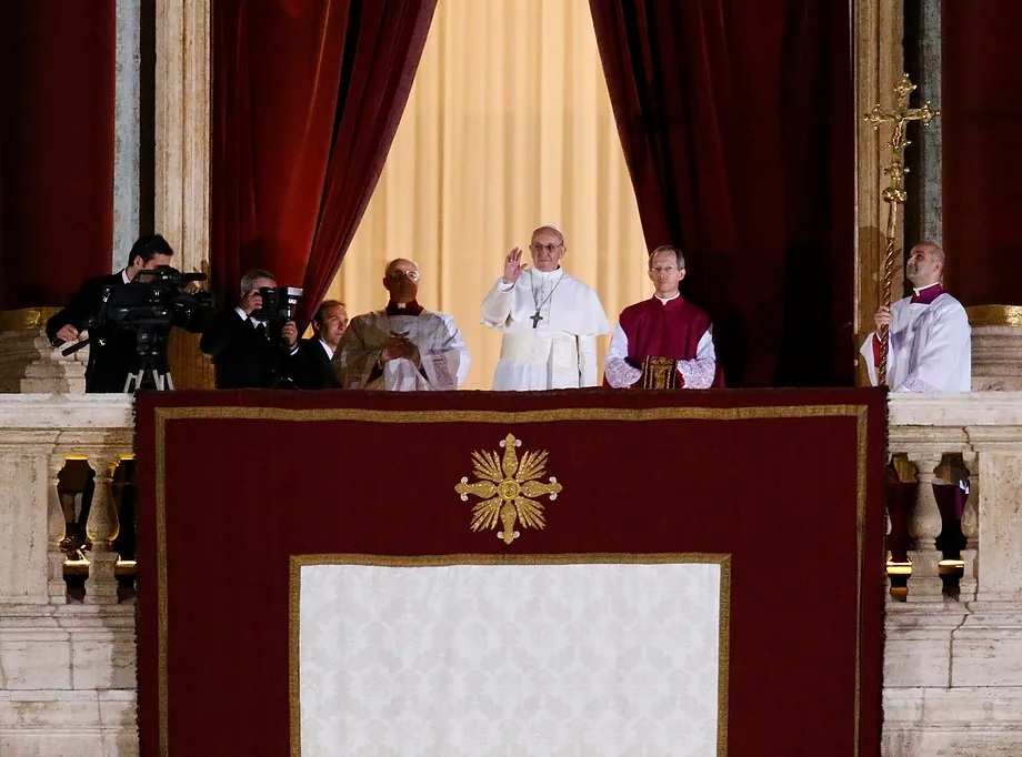 Pope Francis greets from the central balcony of St. Peter's Basilica on Wednesday, March 13, 2013.