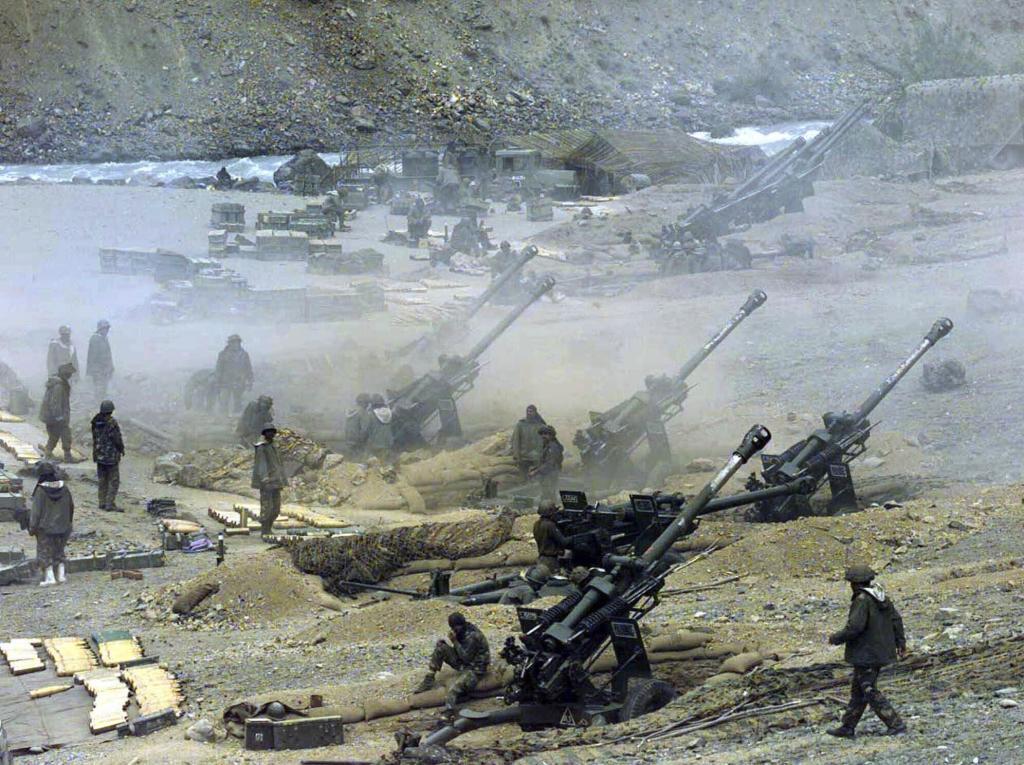 A battery of Indian army artillery guns fire at the positions of Islamic guerillas in the Dras sector of Kashmir,
