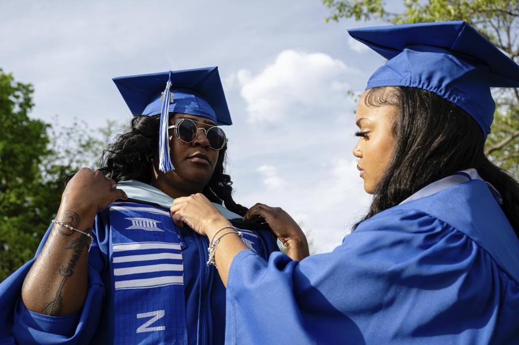 Jocelyn Grimsley prepares her sorority partner before Senior Salute, her special University of Kentucky graduation ceremony,