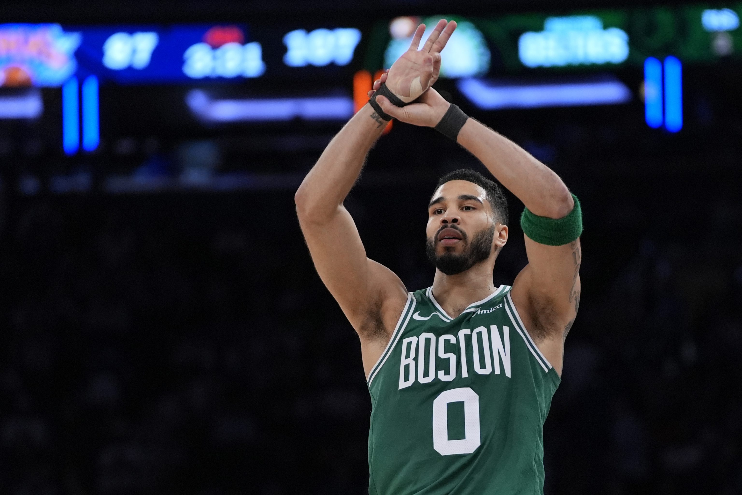 Boston Celtics' Jayson Tatum reacts after scoring a 3-point basket.