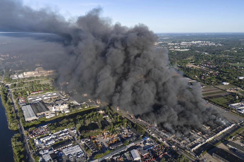 A fire burns from a vast shopping complex in Warsaw.