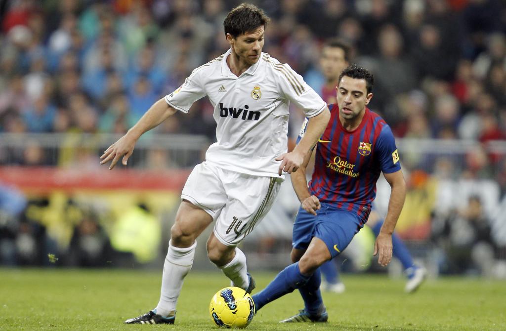 Xavi Alonso, as Real Madrid football player, against Xavi?s Bara footballer.