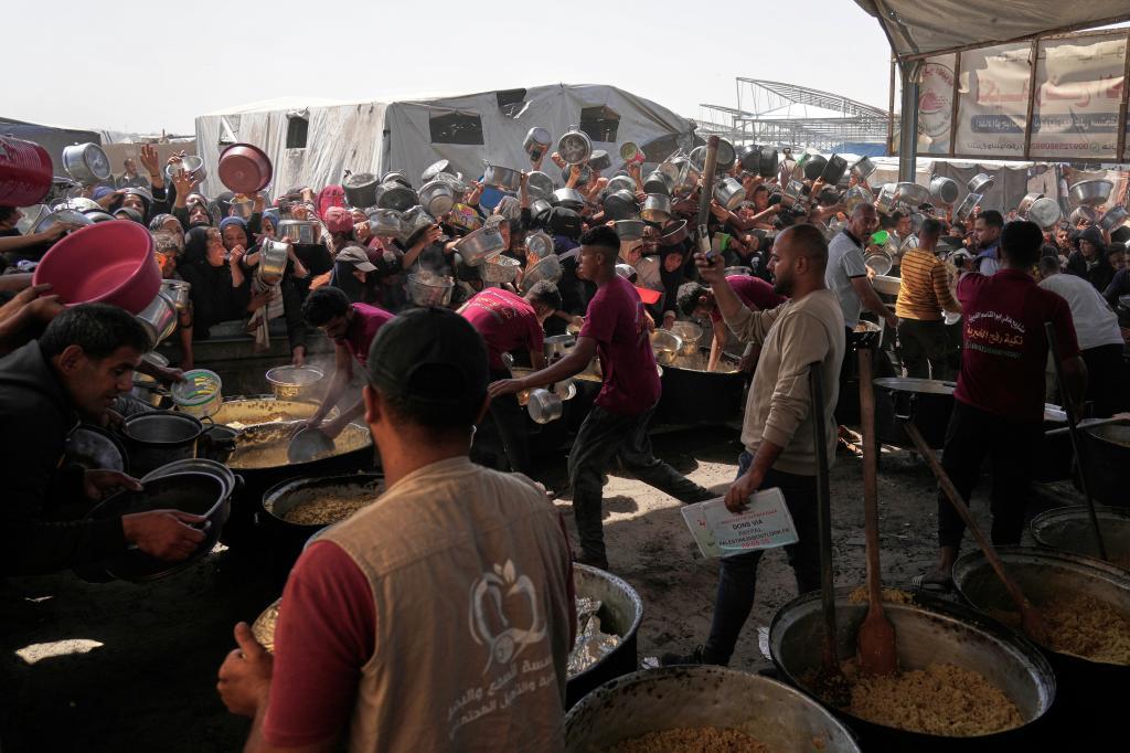 Palestinians struggle to obtain donated food.