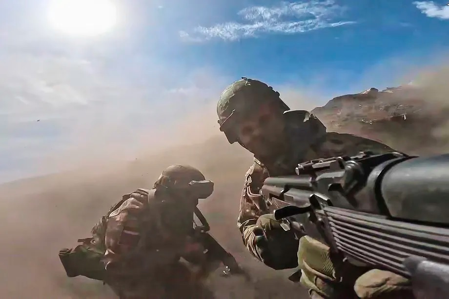 Russian military personnel attend combat training for assault units at an undisclosed location in Ukraine.