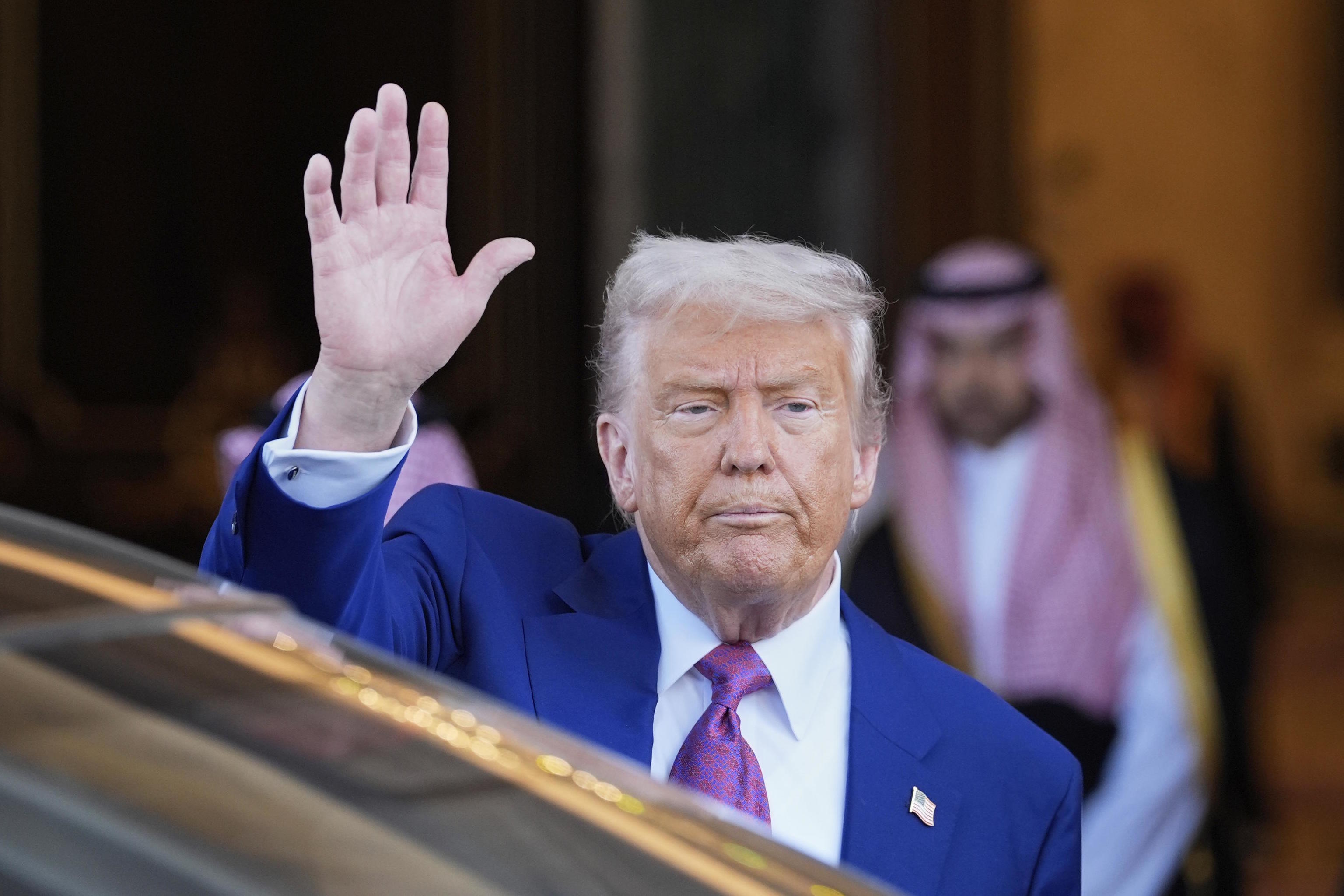 President Donald Trump waves.