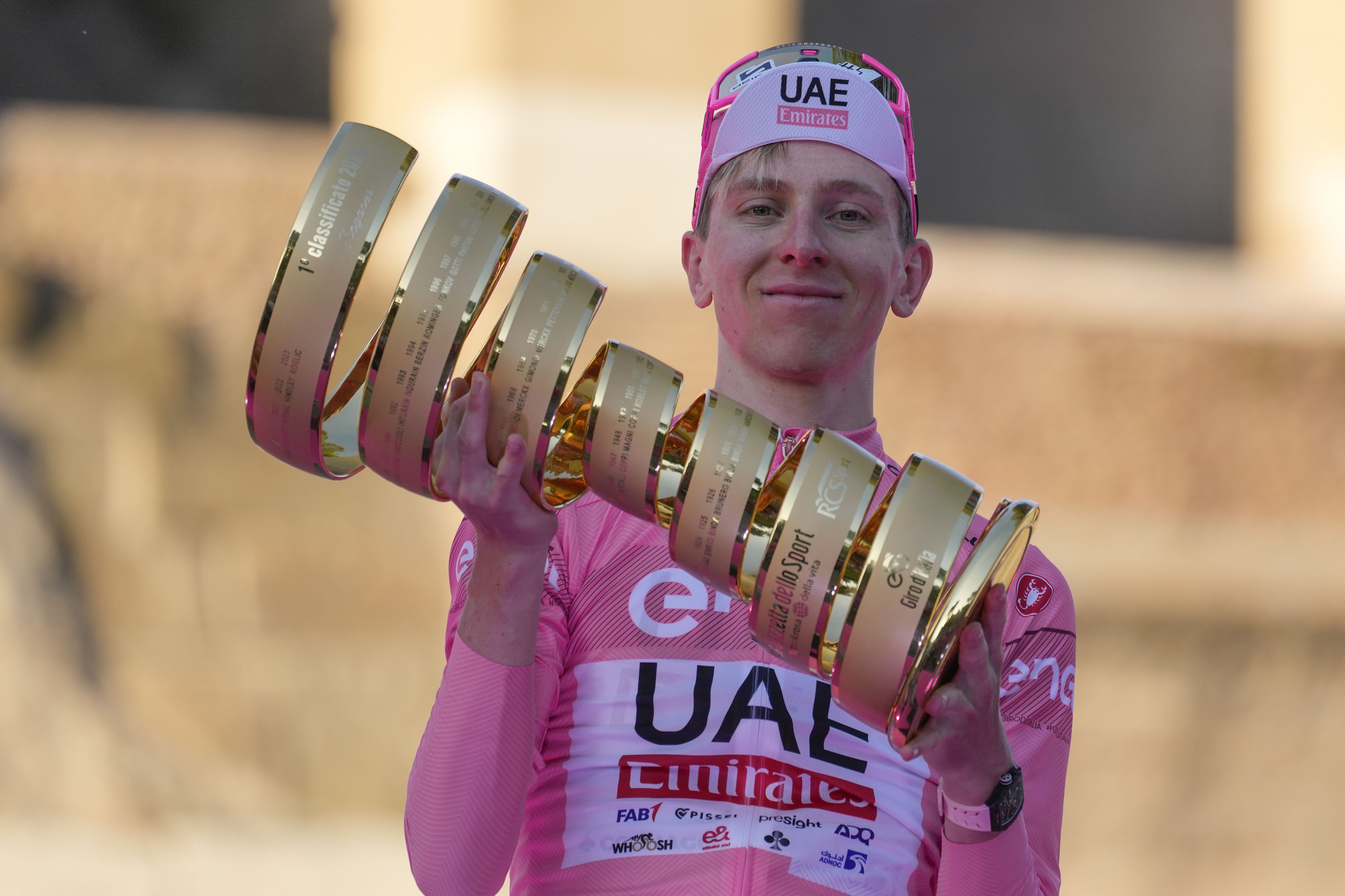 Tour of Italy winner Slovenia's Tadej Pogacar holds the trophy during the podium ceremony at the end of the 21st and last stage of the Giro D'Italia.
