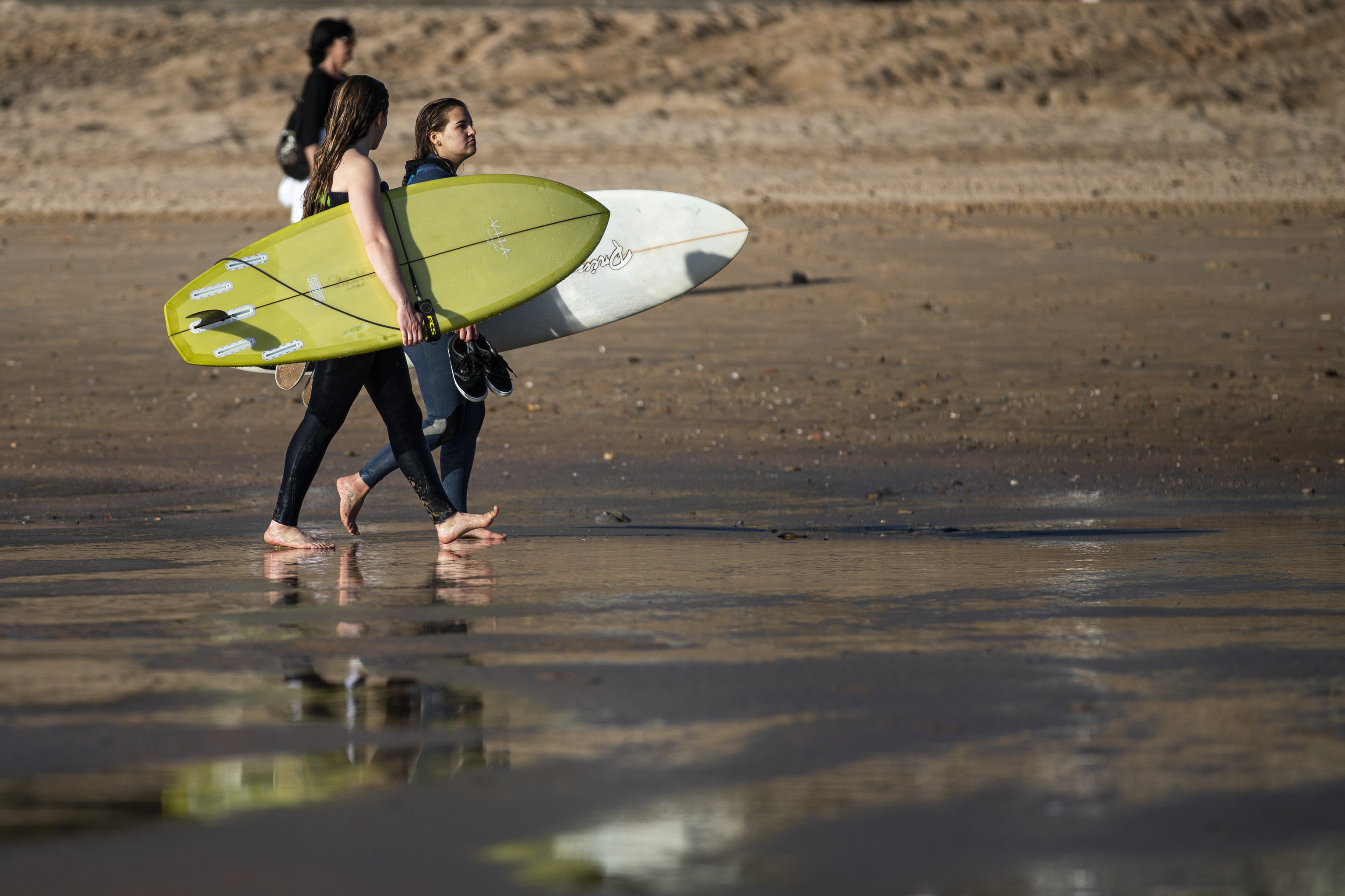 Two surfers on the beach.