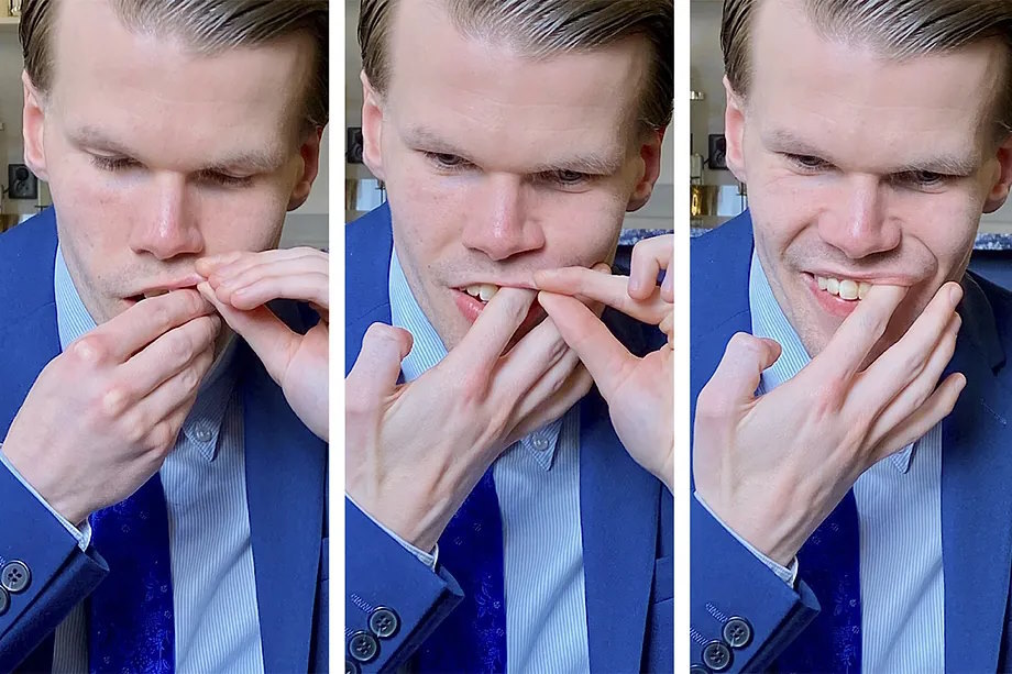 Samuel Lundell, president of the Swedish Snus Consumers Association, inserts a nicotine pouch under his lip.