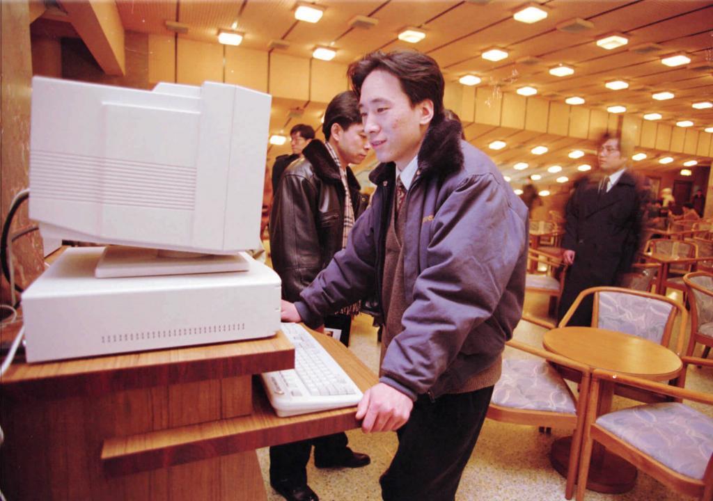 A man searches the Internet at a computer in a Beijing cafe in 1996.
