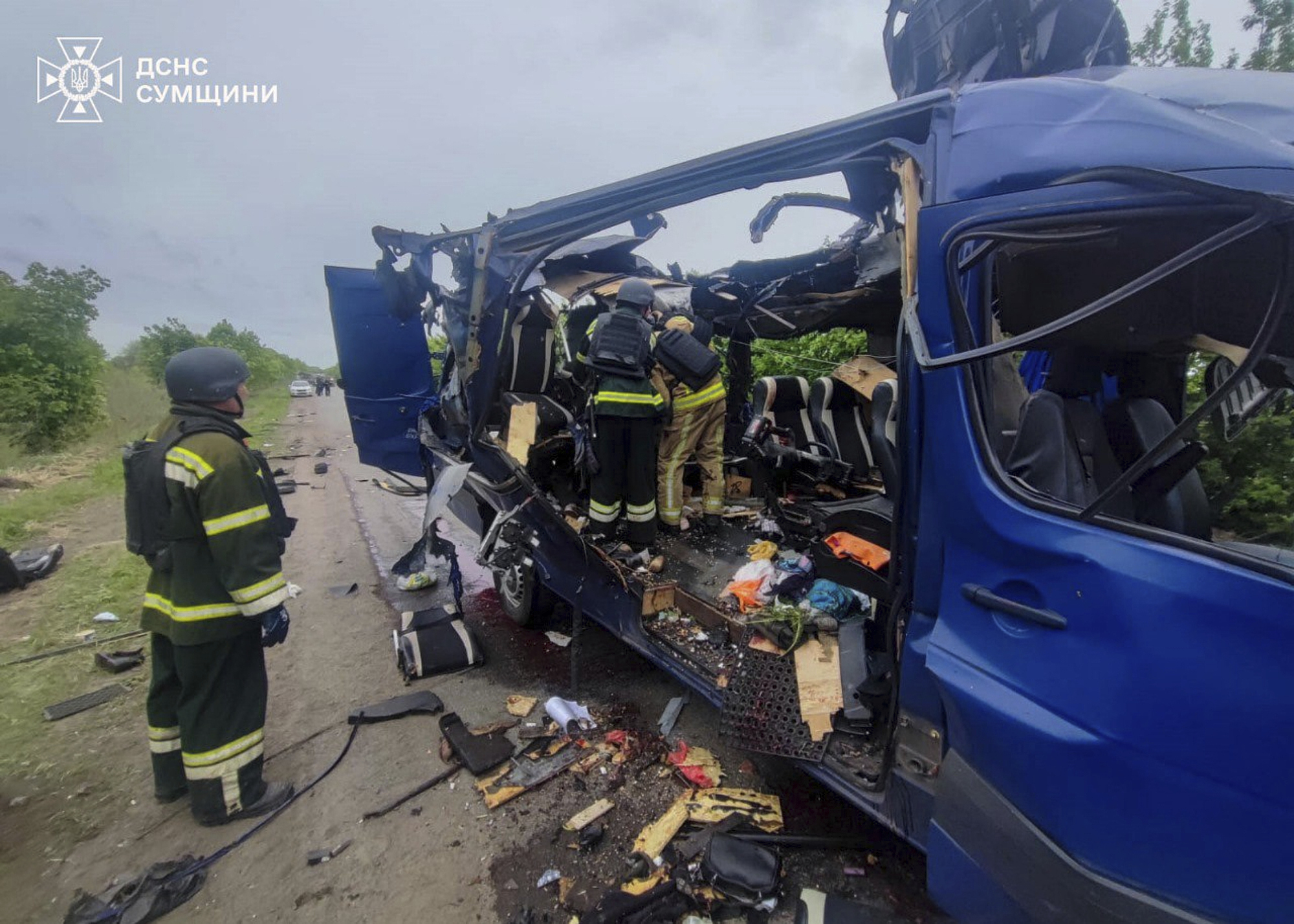 rescuers recover the bodies of passengers after a Russian drone struck a passenger bus at the village of Bilopillya in the Sumy region.