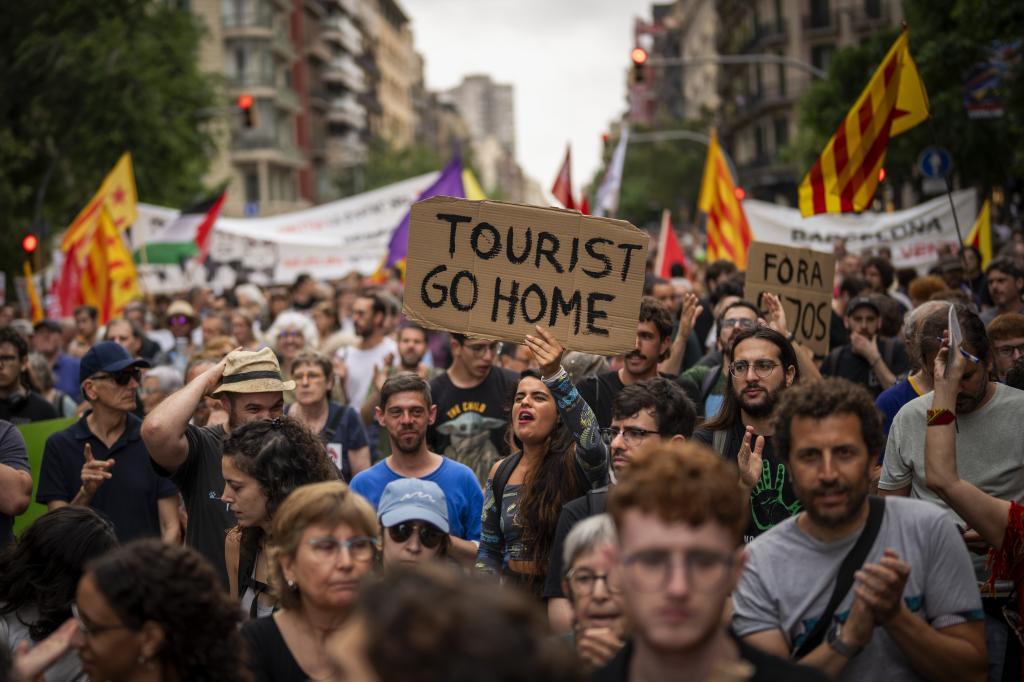 Demonstrators march shouting slogans against the Formula 1 Barcelona Fan Festival i