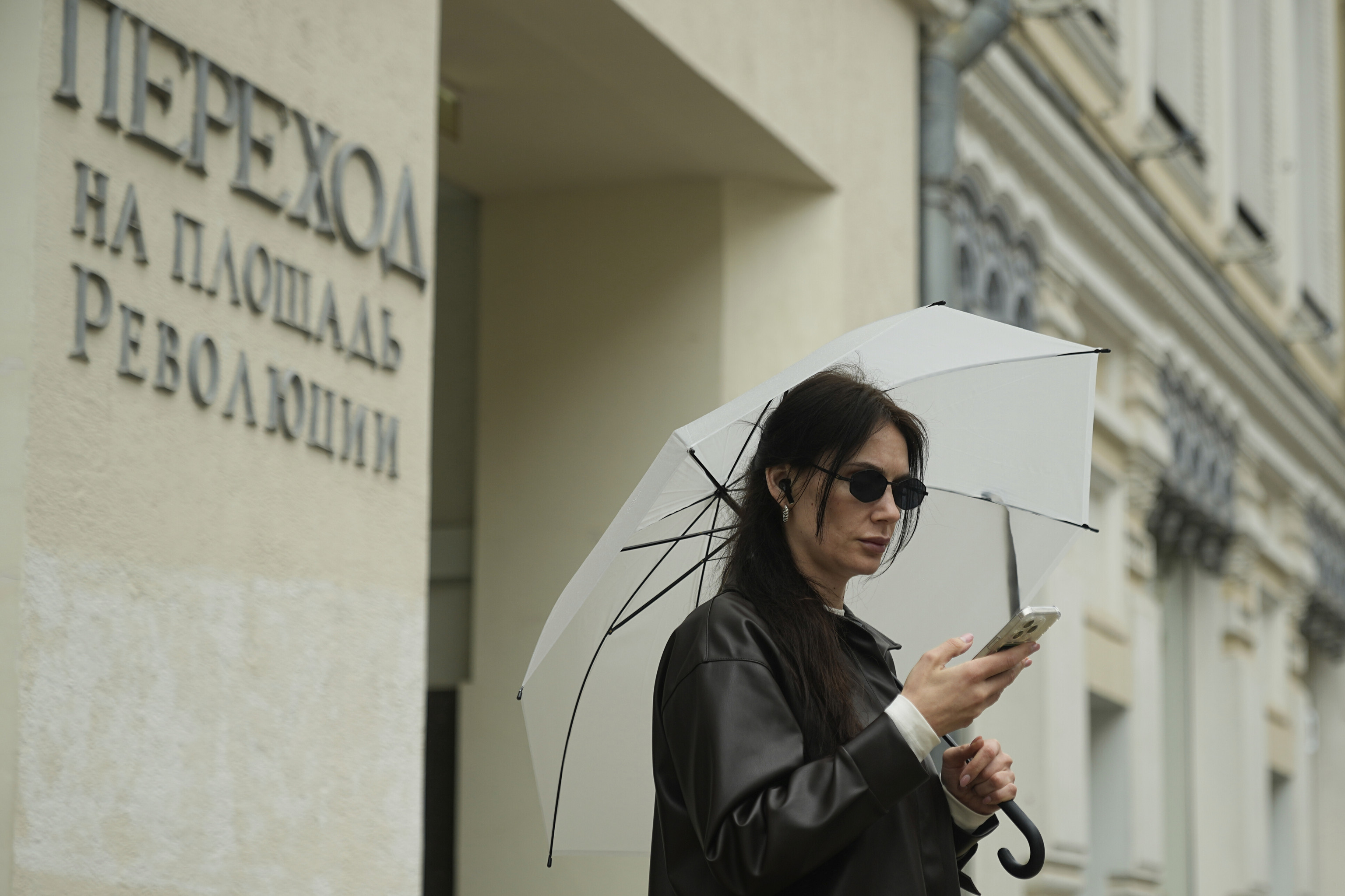 A woman checks her phone.