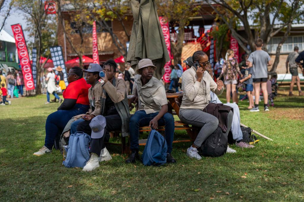 Visitors at the Nampo agricultural fair, one of the largest in the southern hemisphere, sit in there shade near Bothaville