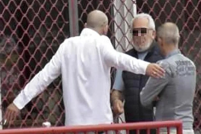 Derbah in a meeting with his associates captured by Internal Affairs.