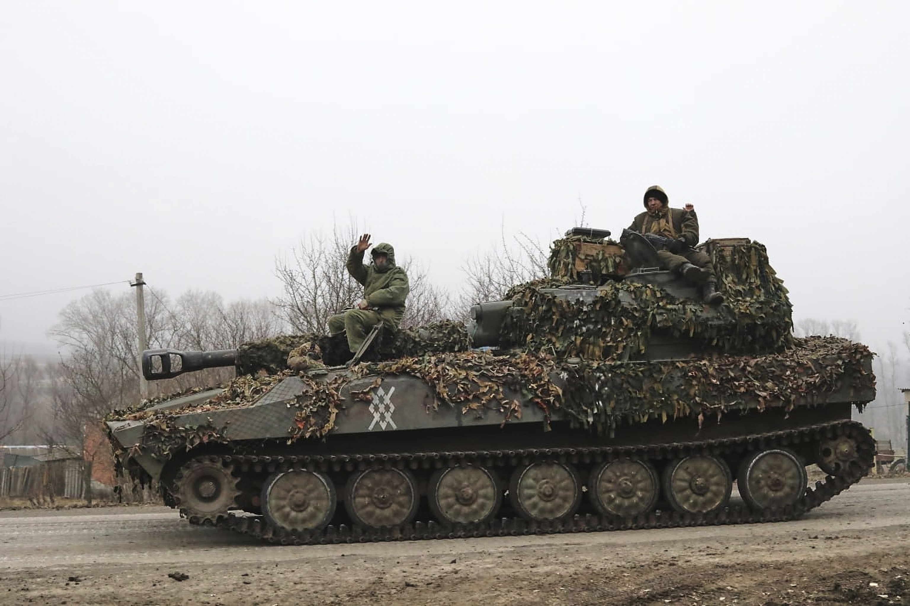 Russian soldiers ride on a self-propelled gun in Russia's Kursk region.