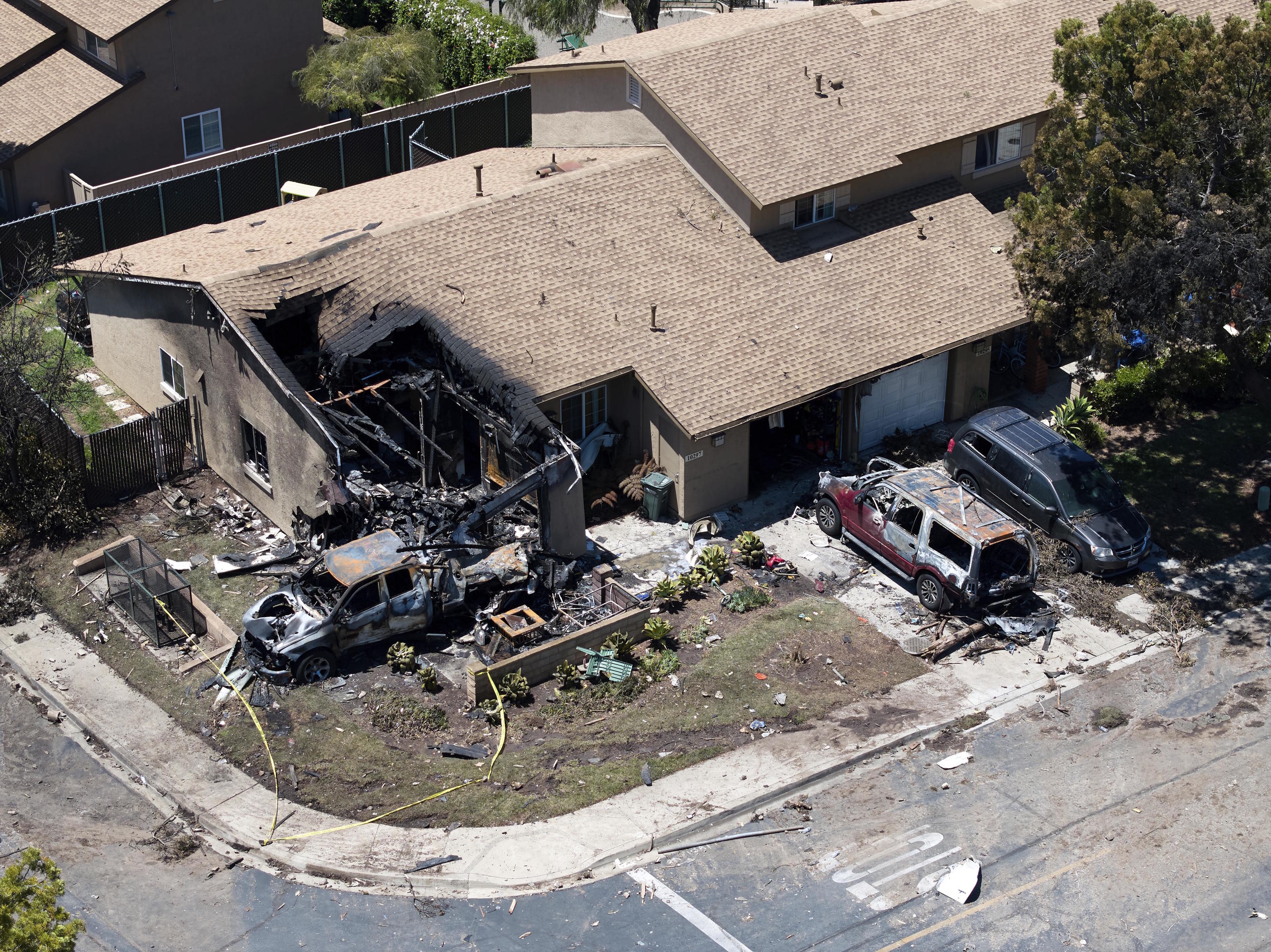 Debris covers the ground after a small plane crashed into a San Diego neighborhood.