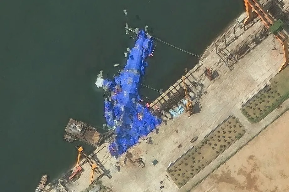 Satellite image of the capsized ship in the shipyard covered with a tarp.