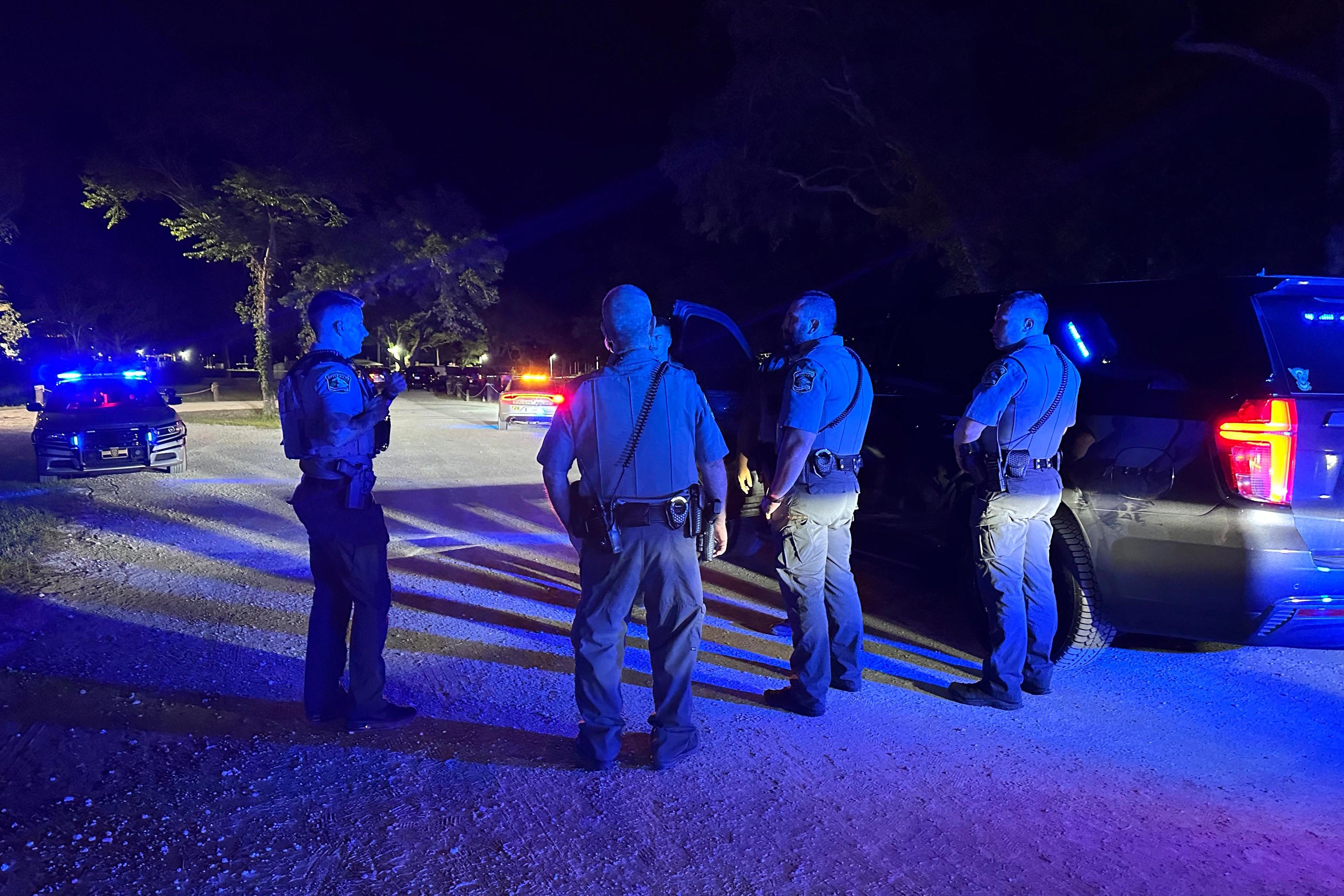 Police officers respond to the scene of a shooting on Sunday.