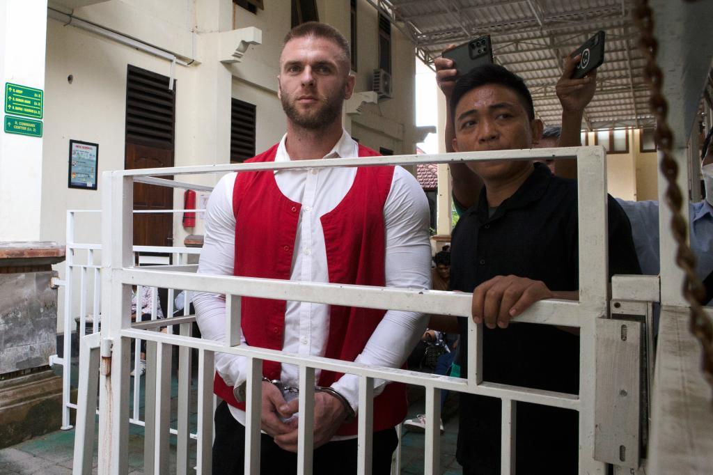 British citizen Thomas Parker, left, walks to a holding cell after he is sentenced for drug offenses