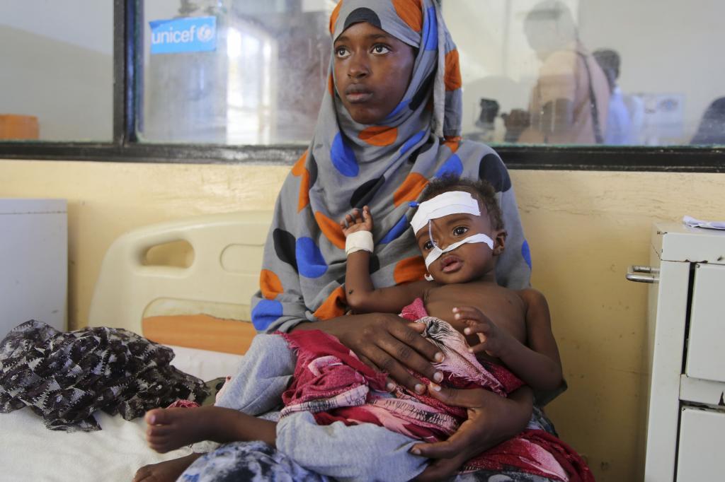 A Somali woman cares for her baby at Banadir Hospital in Mogadishu, Somalia,