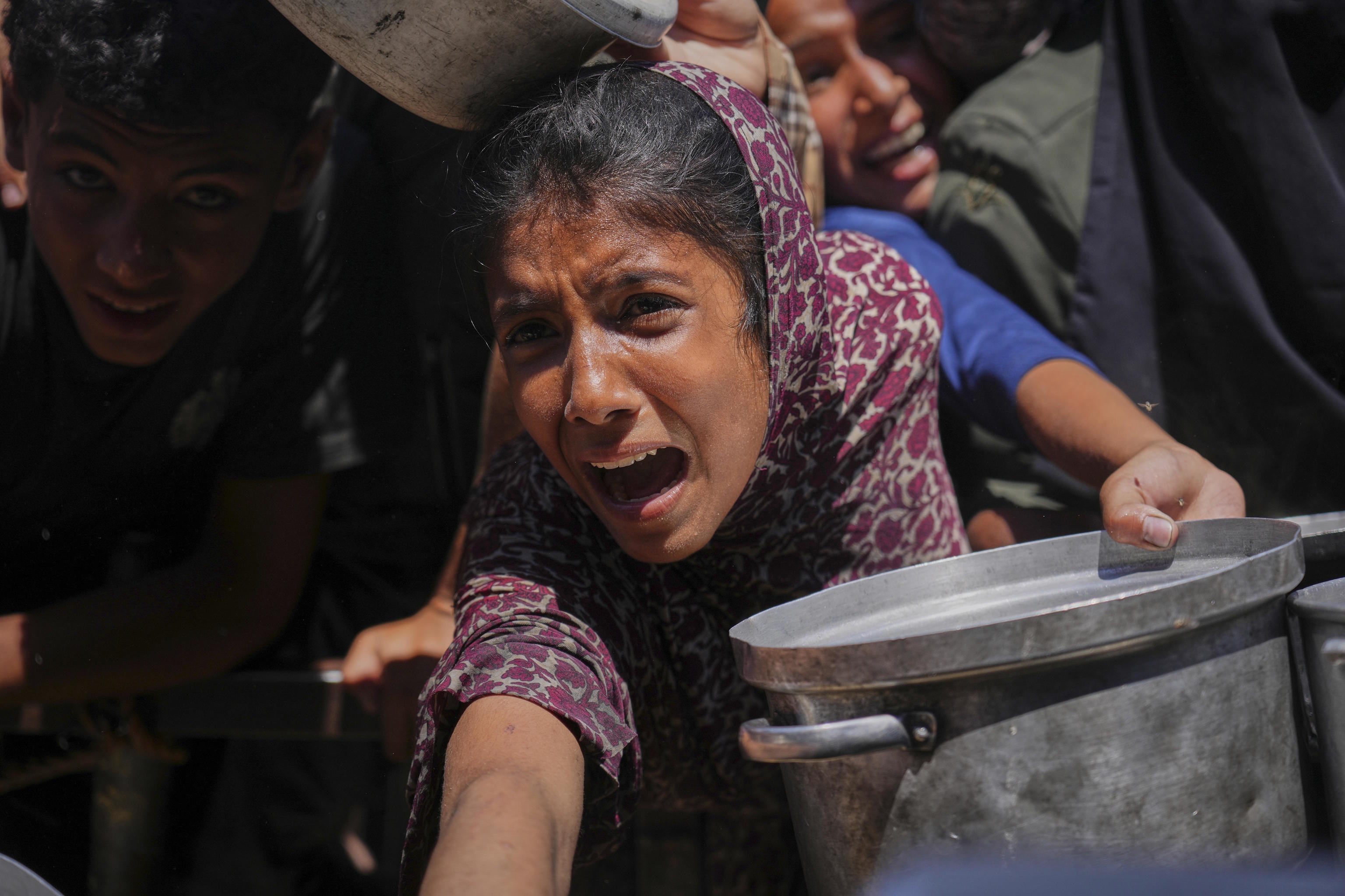Palestinians struggle to receive food in the Gaza Strip.
