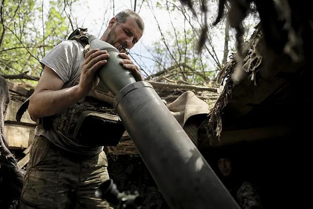 A Ukrainian soldier loads a mortar at the Chasiv Yar front in Donetsk.