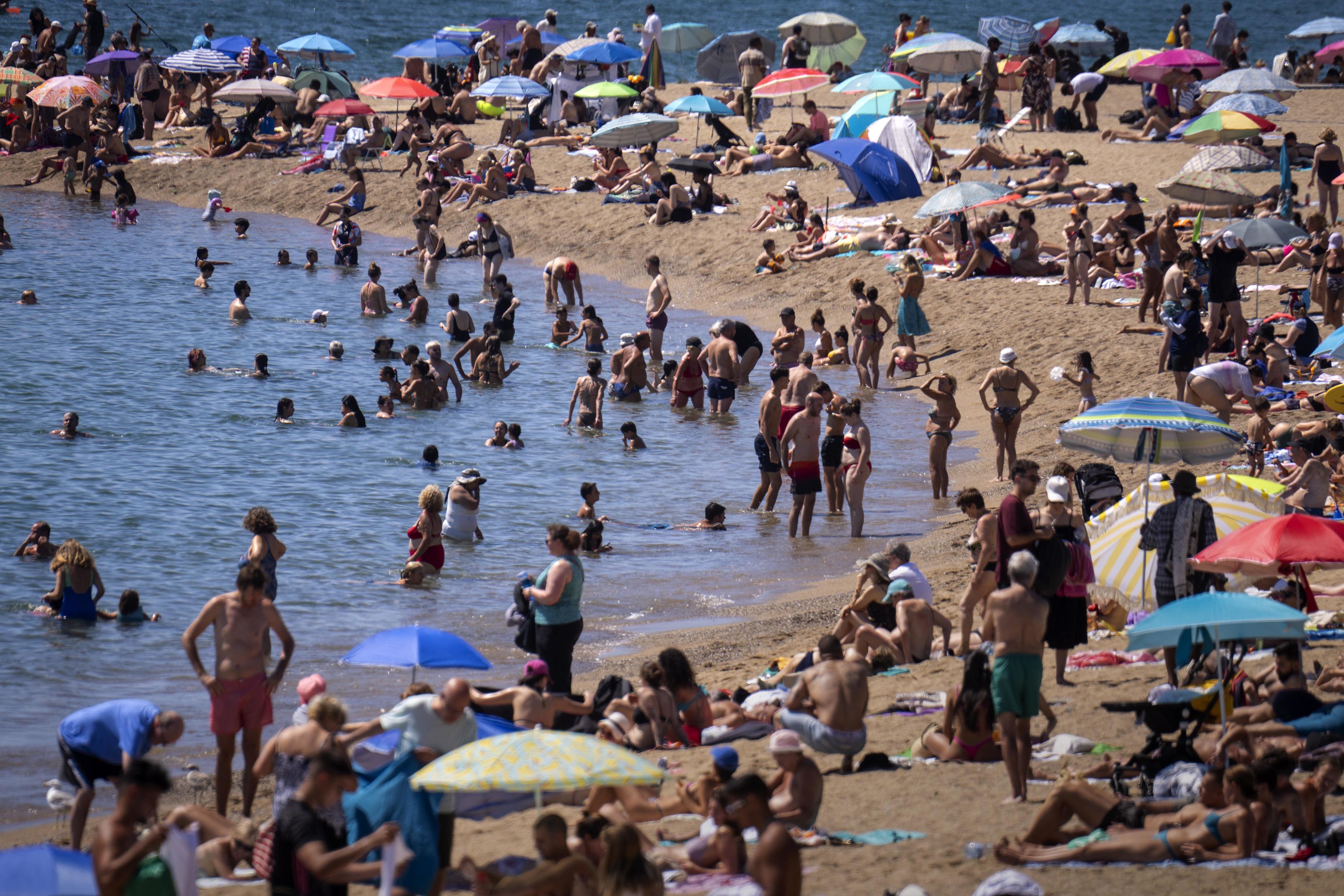Bathers cool off in the water on a Barcelona beach, Spain.
