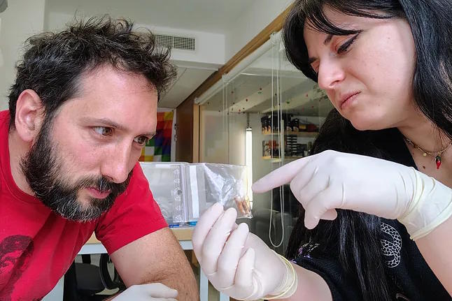 Researchers from the Pasteur Institute, examining one of the teeth.