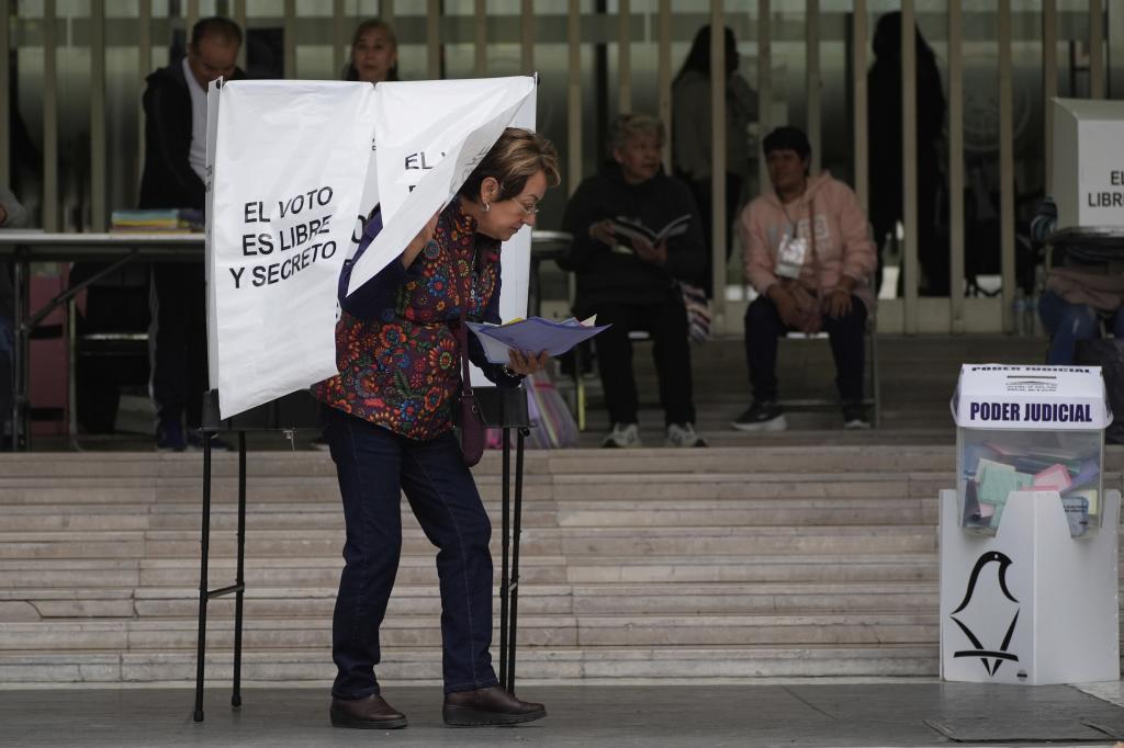 A voter leaves after casting her ballot in Mexico's first judicial elections