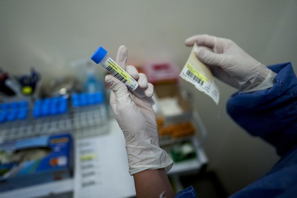 A heath worker is about to take a sample in Buenos Aires