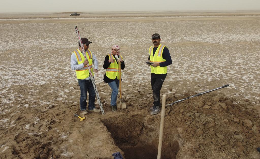 Archaeologists work at an archaeological site where researchers uncovered massive earthen structures