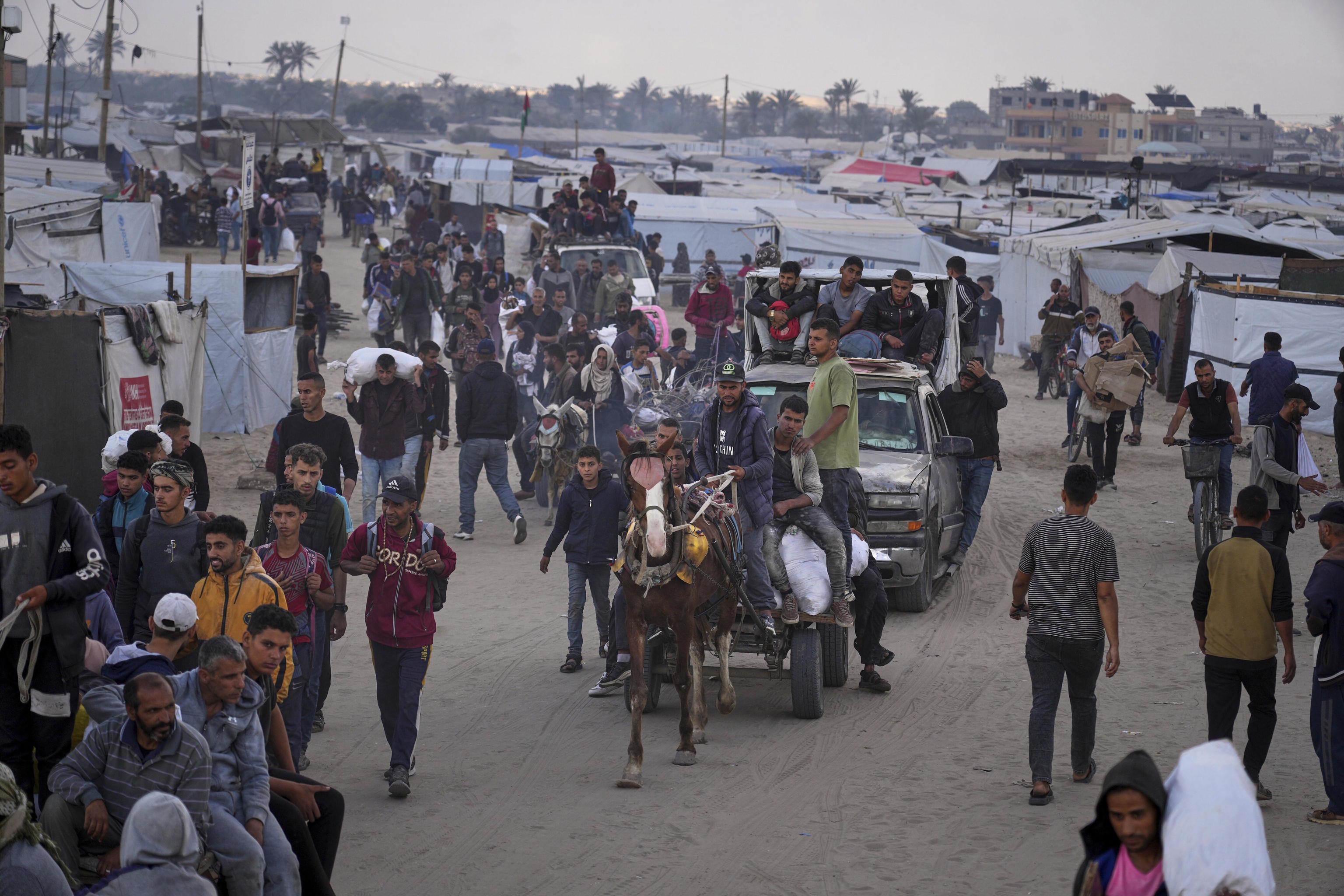 Palestinians carry food provided by the Gaza Humanitarian Foundation.