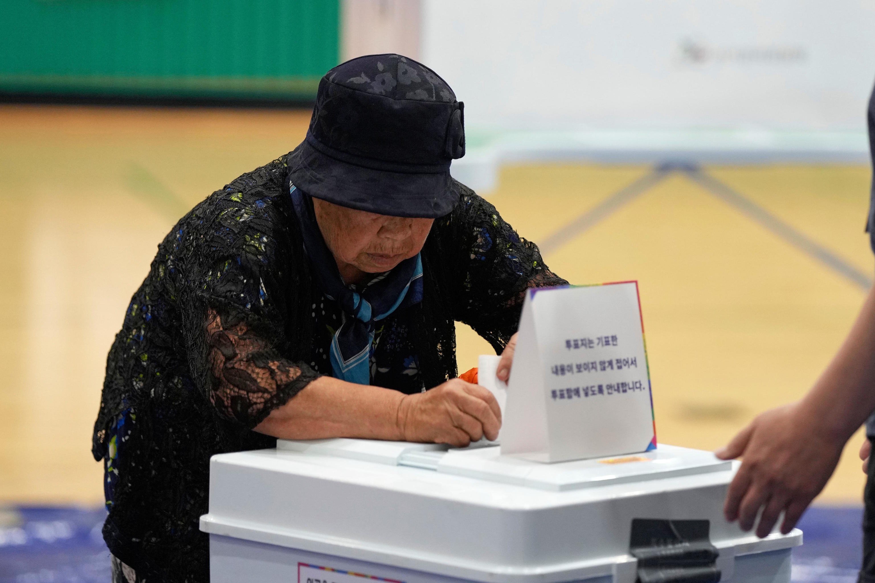 A woman casts her vote for the presidential election in Seoul.