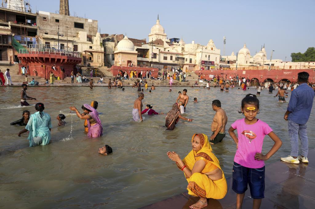 Hindu devotees pray and take holy dips at the Saryu River