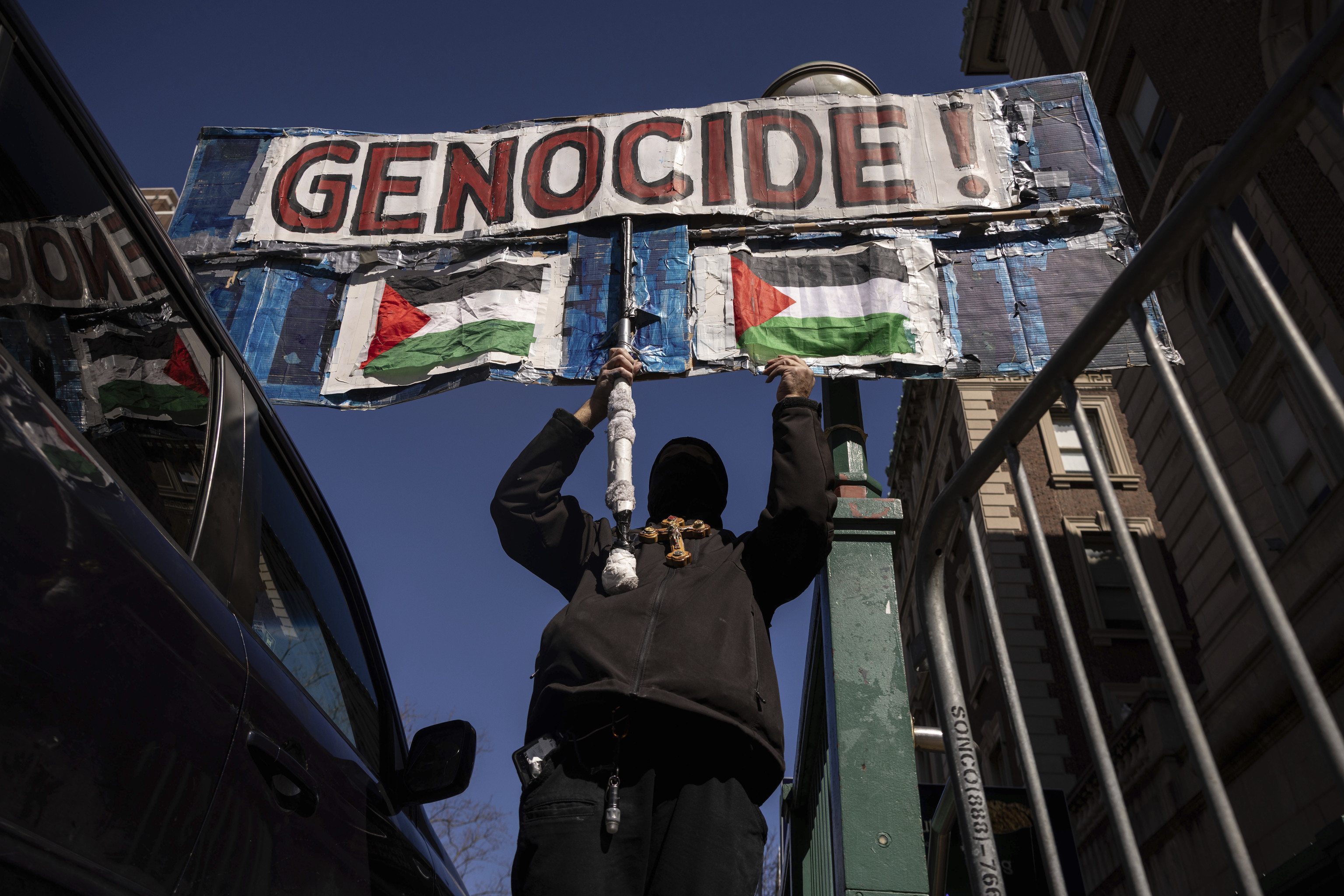 A protester raises a sign during their demonstration in support of Palestinian activist Mahmoud Khalil.