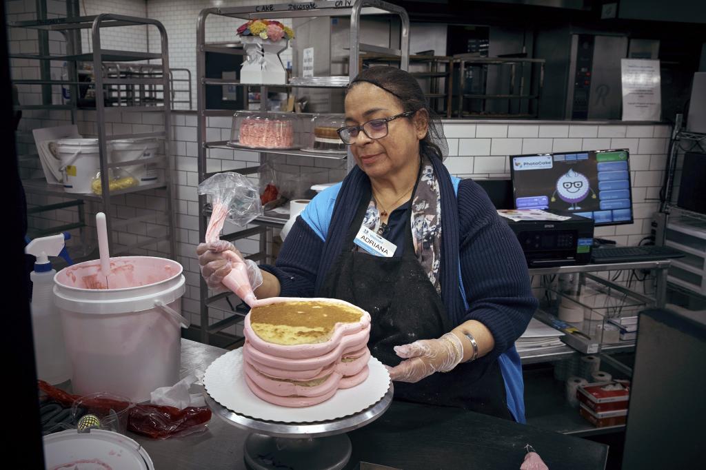 An employee makes a cake inside Walmart Supercenter