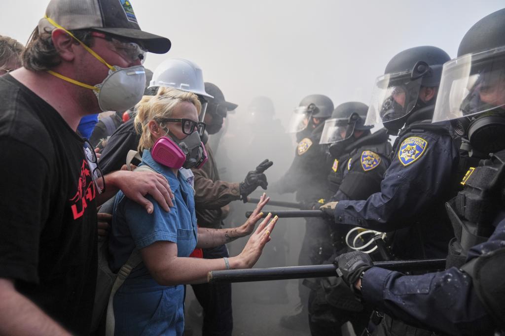 Protesters confront police on the 101 Freeway near the Metropolitan Detention Center of downtown Los Angeles,