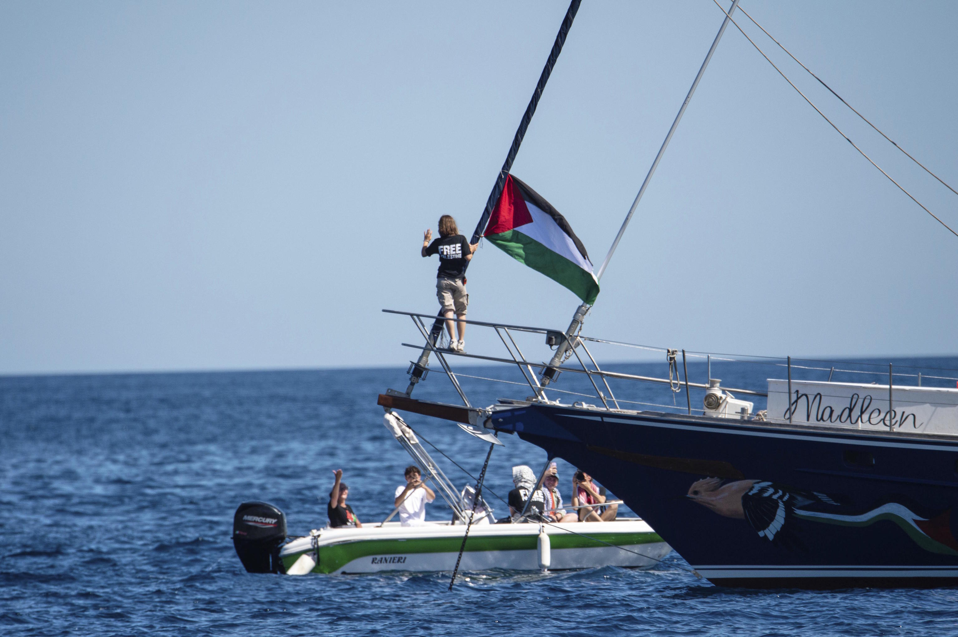 Greta Thunberg is seen next to a Palestinian flag on the Madleen sailboat.