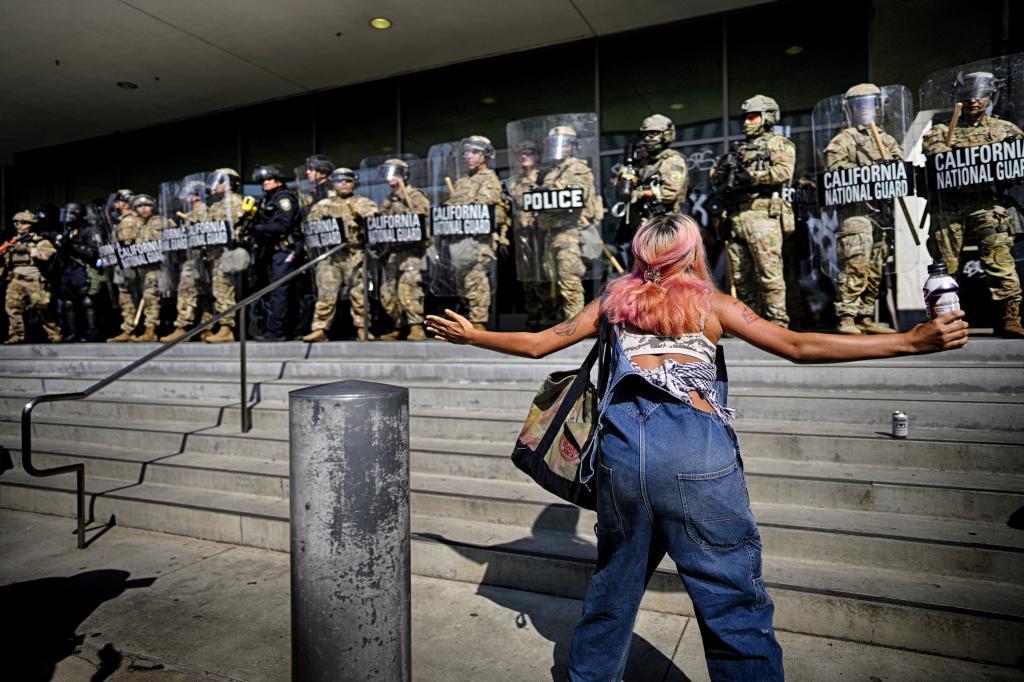 A protester taunts a line of California National Guard