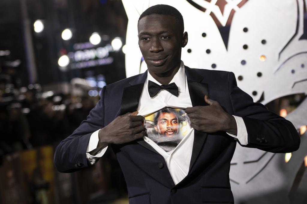 Khaby Lame opens his shirt to reveal the image of Chadwick Boseman