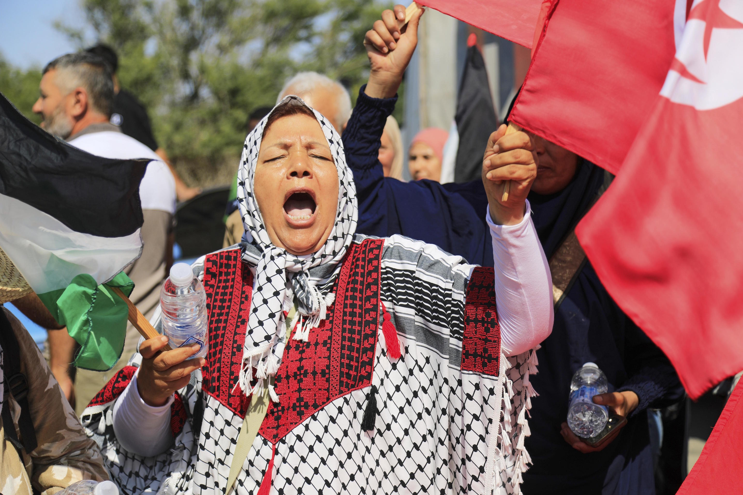 Members of a humanitarian convoy shout slogans.