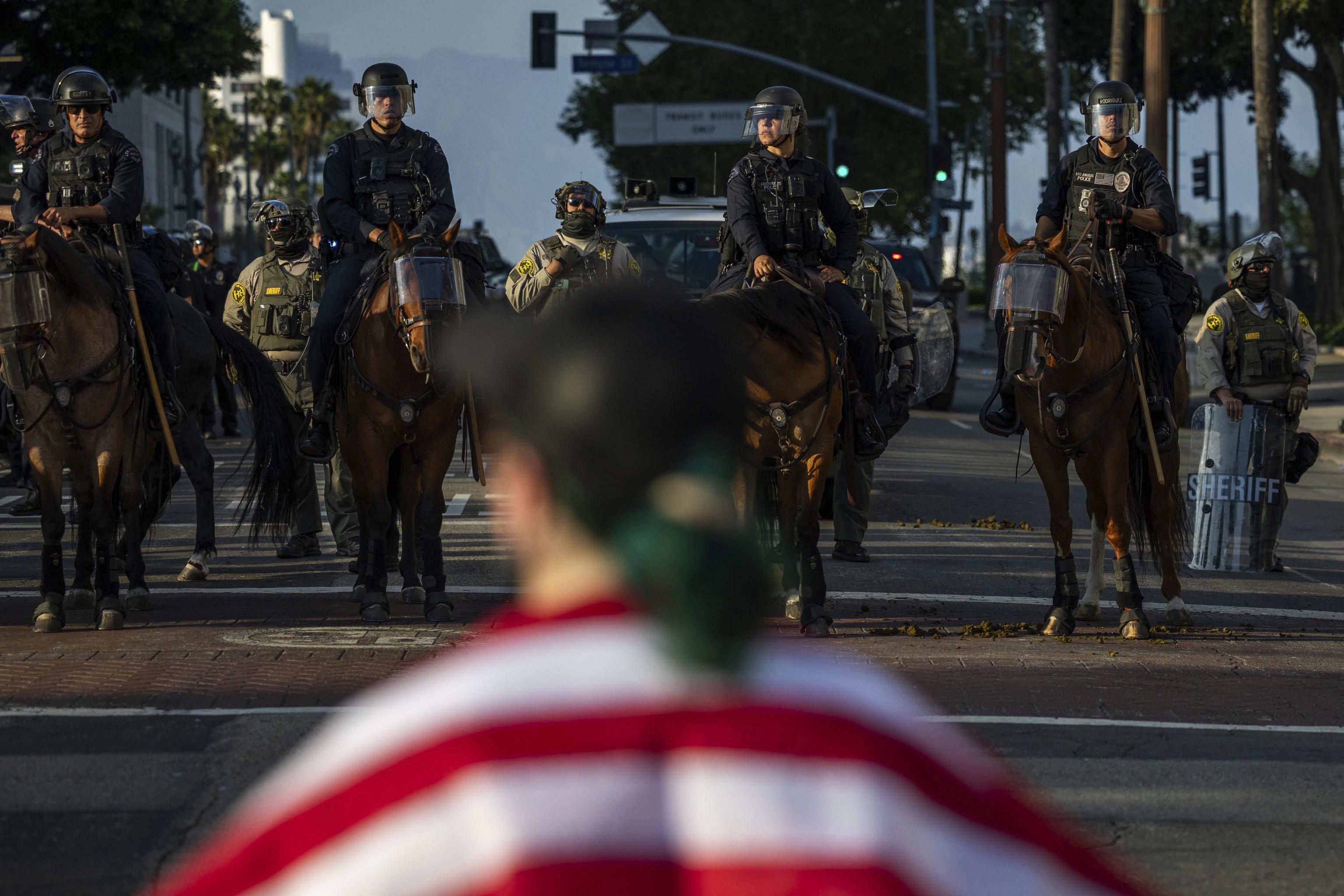 Police confront protesters outside City Hall.