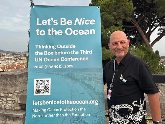 Rmi Parmentier poses in Nice with a sign from his campaign to protect the oceans.