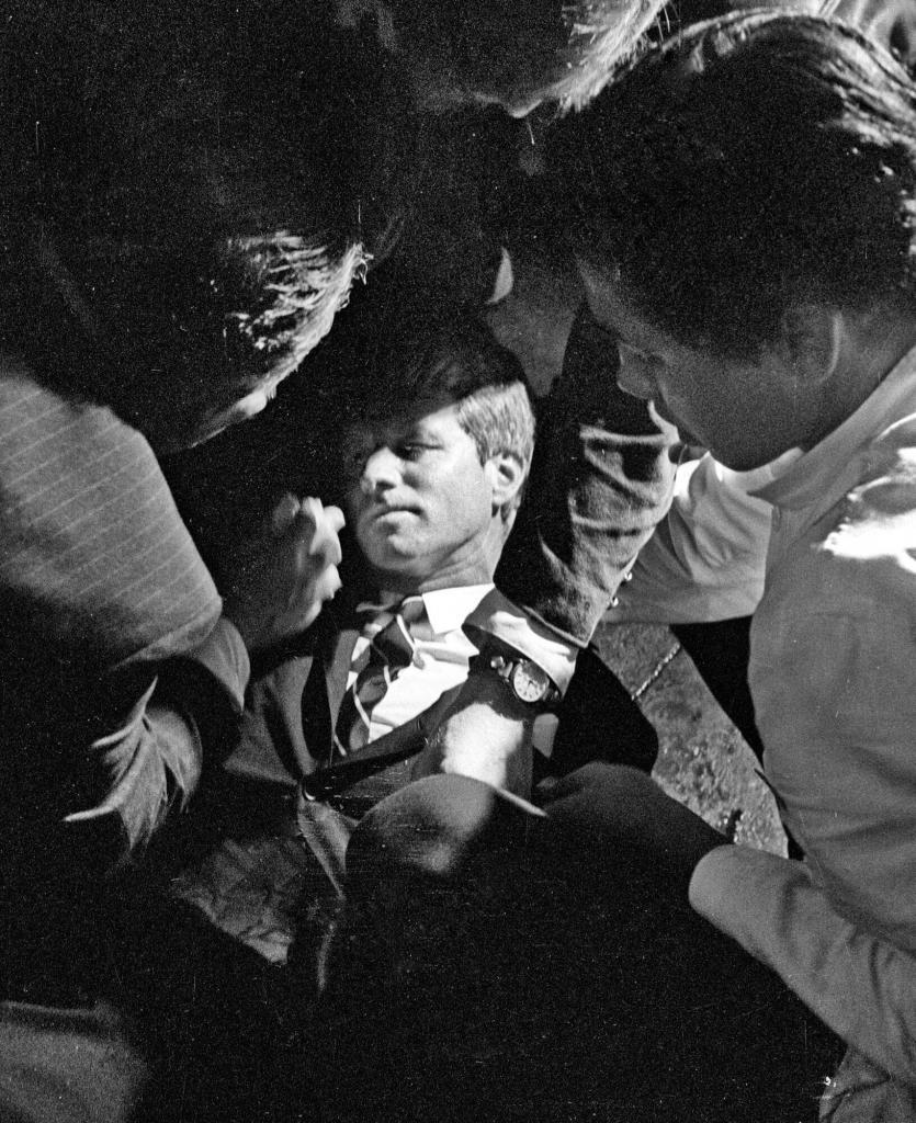 Hotel busboy Juan Romero, right, comes to the aid of Senator Robert F. Kennedy, as he lies on the floor of the Ambassador hotel in Los Angeles moments after he was shot.