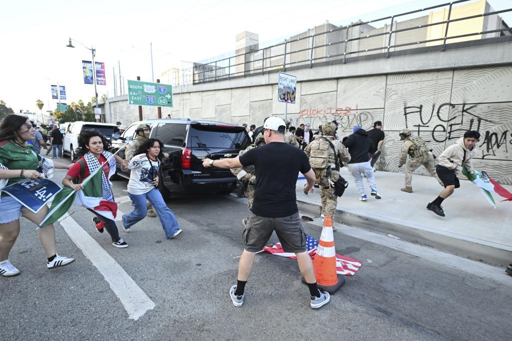 Demonstrators clash with members of the California National Guard