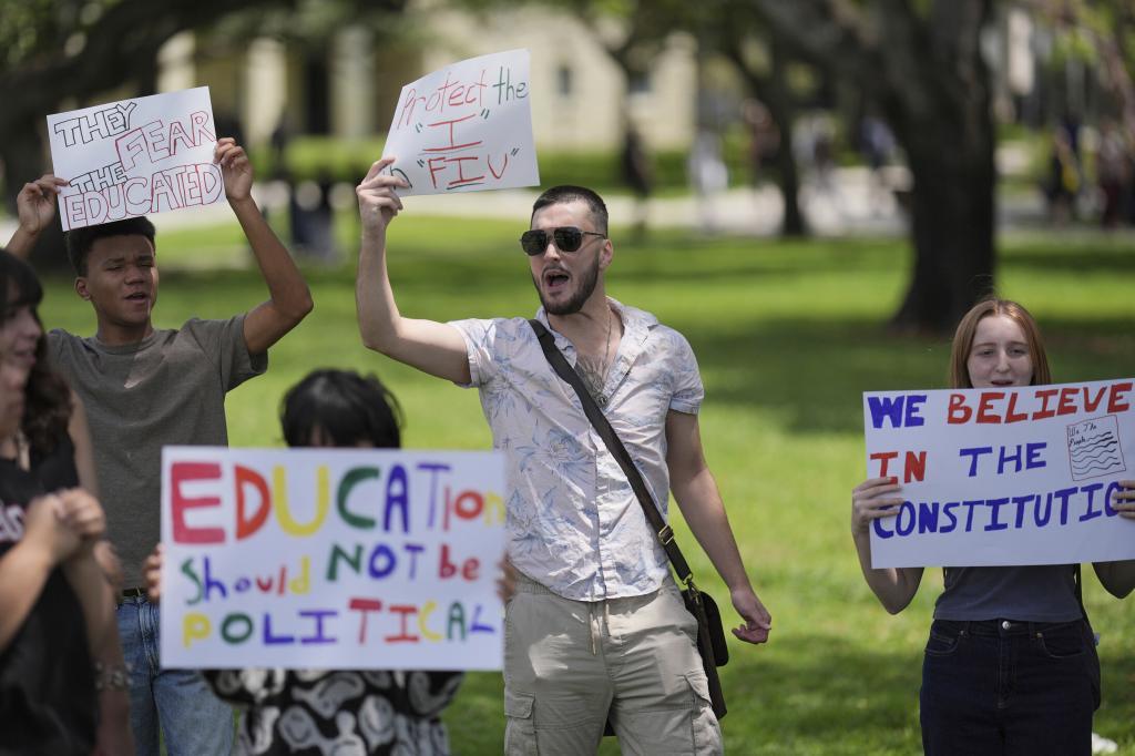 A group of Florida International University students protest against cuts in federal funding and an agreement by campus police to partner with Immigration and Customs Enforcement